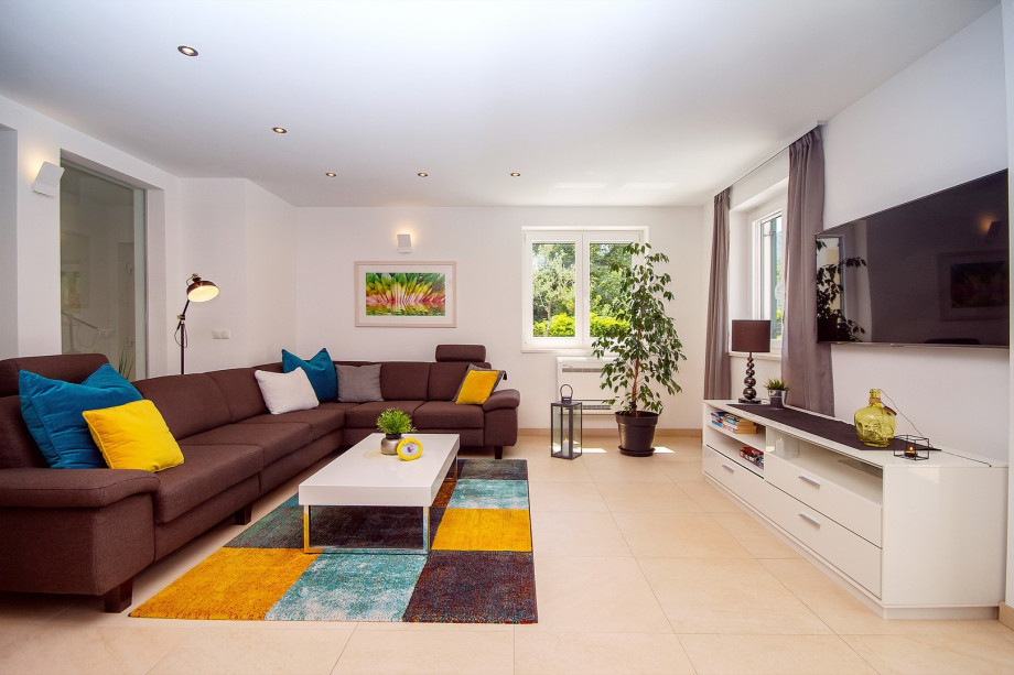 Living room with exit to pool area, all is air-conditioned