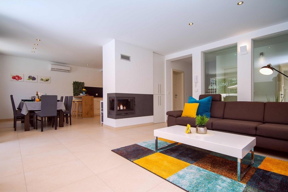 Living room and dining area with exit to pool area, all is air-conditioned