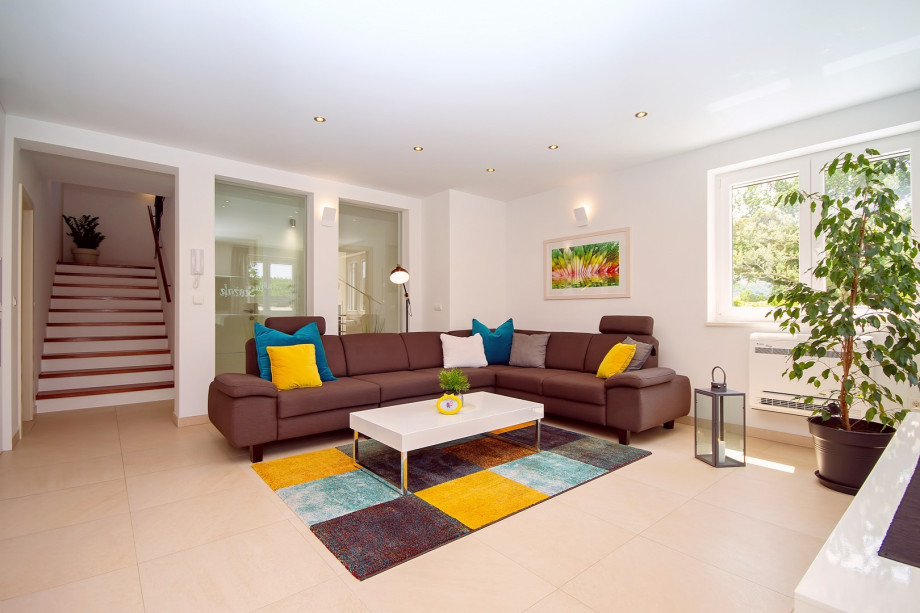 Living room and dining area with exit to pool area, all is air-conditioned