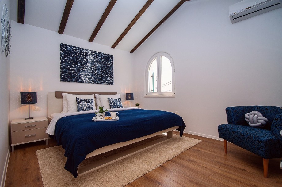 Schlafzimmer NO2 mit Doppelbett 180x200 und einem Einzelbett in einem separaten Raumteil