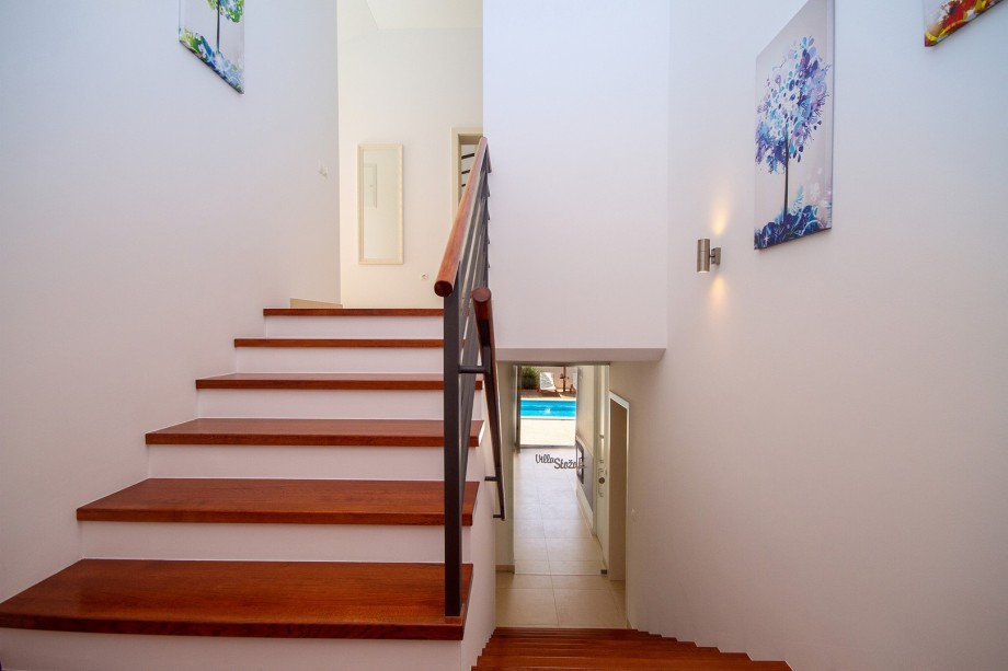 A wooden staircase that takes you to bedrooms
