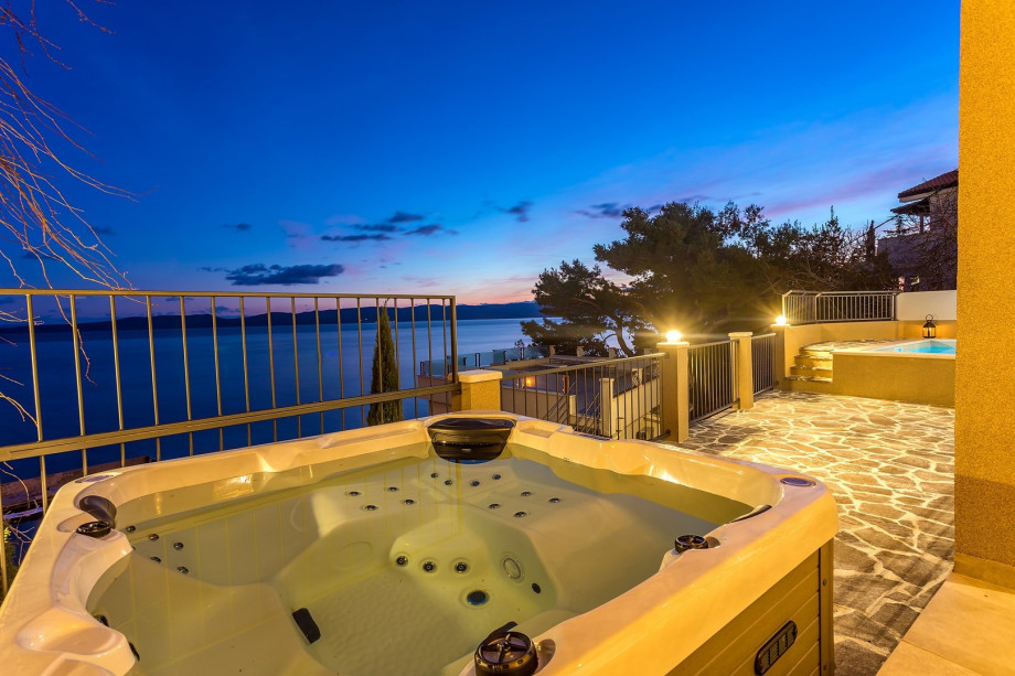 Perfect nights in the private  jacuzzi surrounded by lights with a sea and island view
