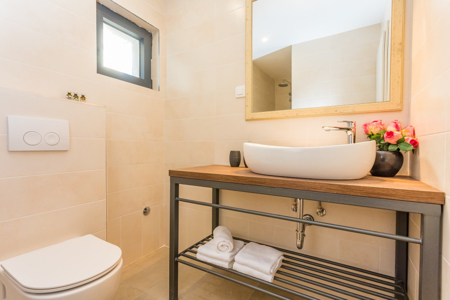 Family bathroom with a shower and a laundry room with a washer and dryer (next door)