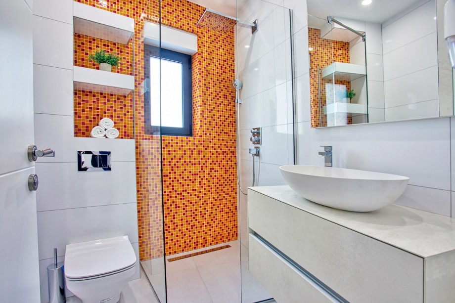 An en-suite bathroom with a shower, a sink, and a toilet