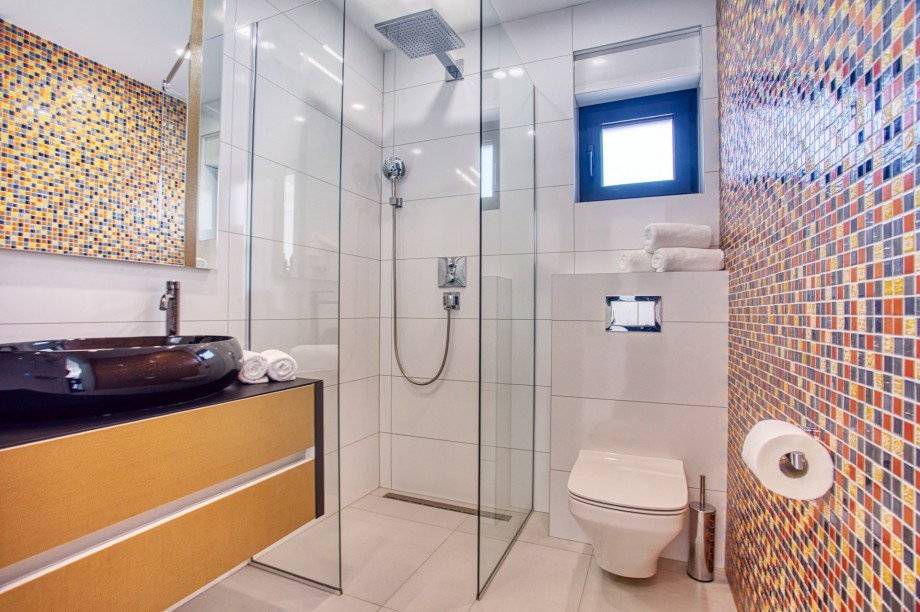 An en-suite bathroom with a shower, a sink, and a toilet