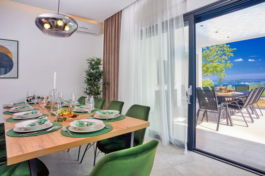 Comfortable dining area for 10 people with an exit to the outdoor dining area