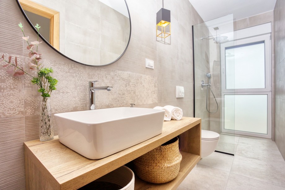 An en-suite bathroom with a shower, a sink, and a toilet