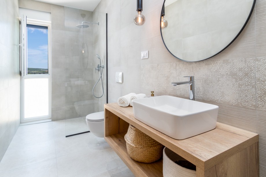 An en-suite bathroom with a shower, a sink, and a toilet