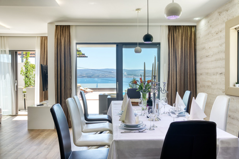 Spacios dining area for 12 with open pool and sea view