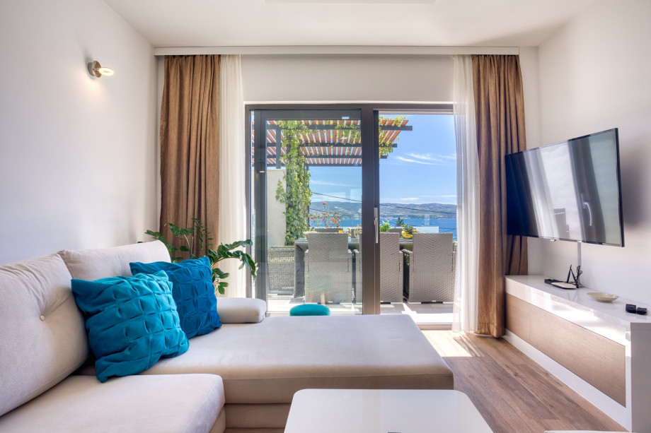 Living area with TV and exit to the pool area