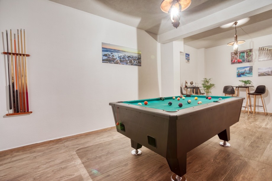 Pool table at garage level, basement