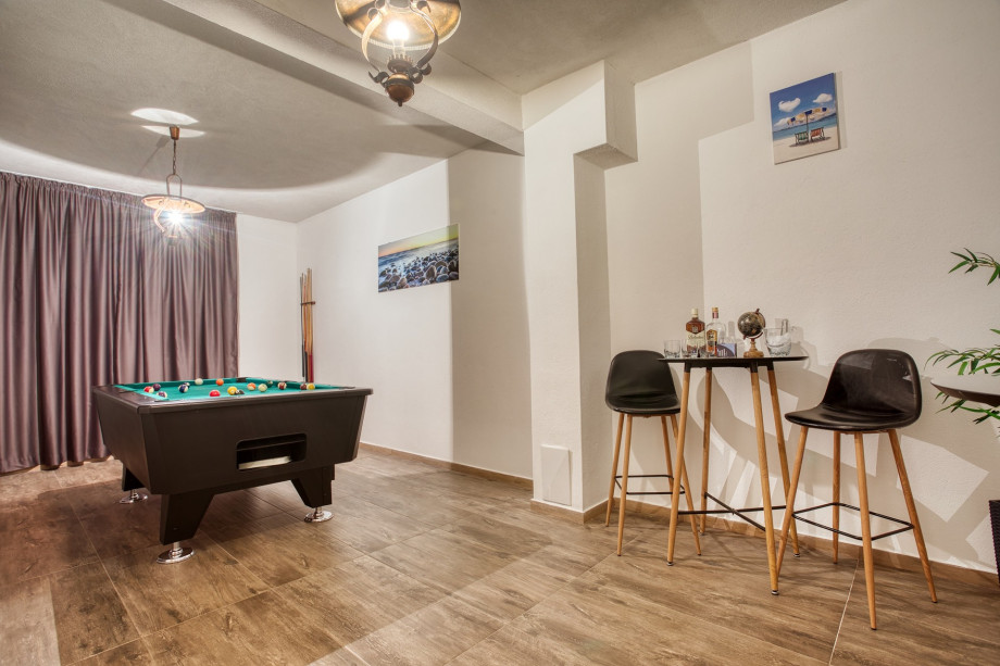 Pool table at garage level, basement