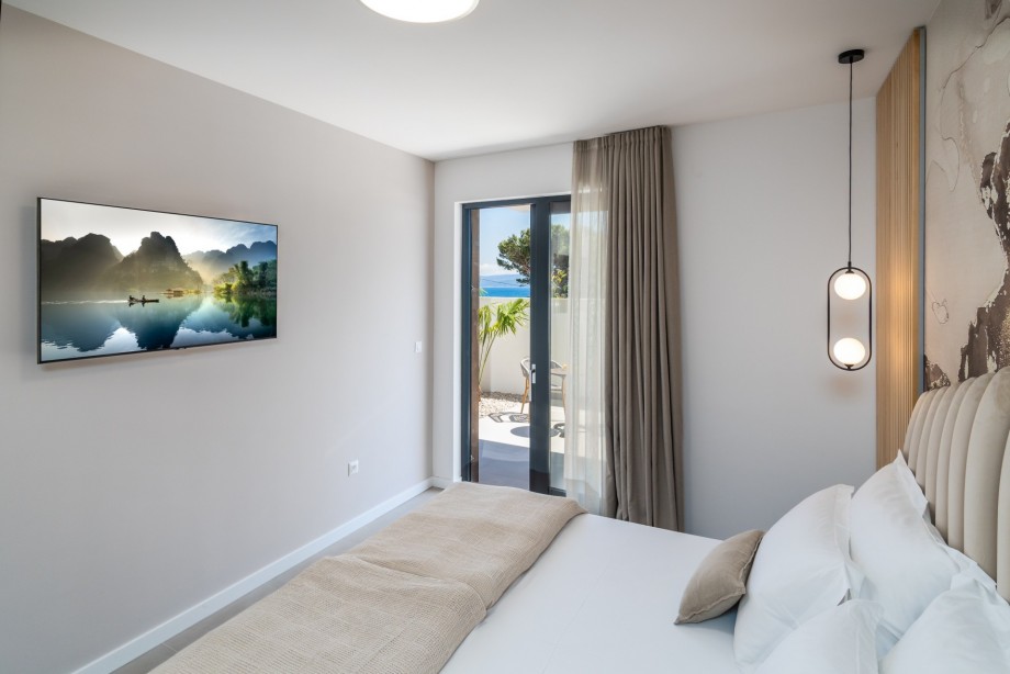 Bedroom No1 offers an en-suite bathroom with shower, A/C, TV, and exit to a terrace