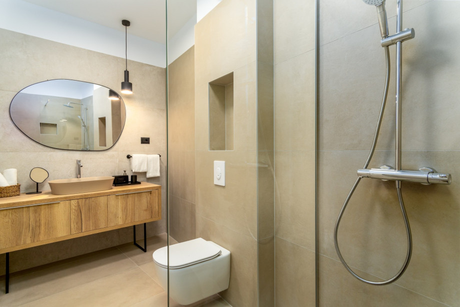 An en-suite bathroom with a shower, a sink, and a toilet