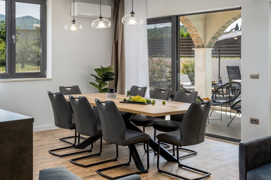 Comfortable dining area for 8 people with an exit to the outdoor dining area