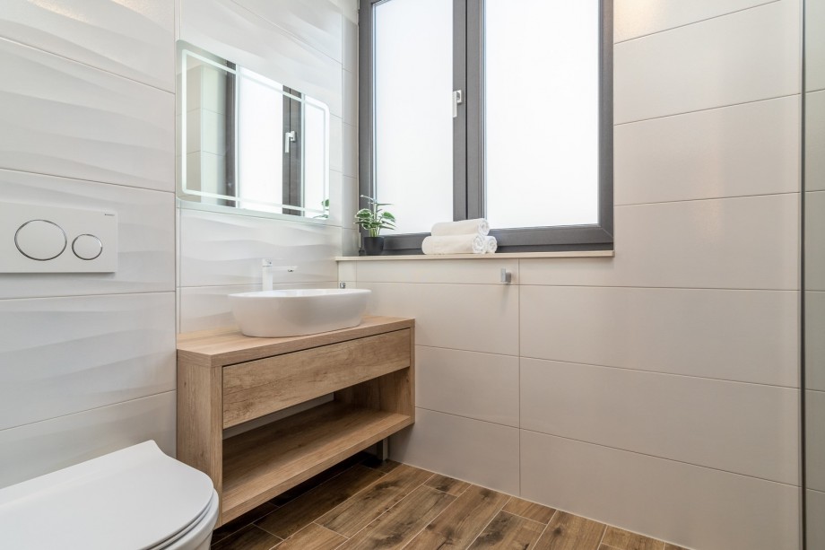 An en-suite bathroom with a shower, a sink, and a toilet