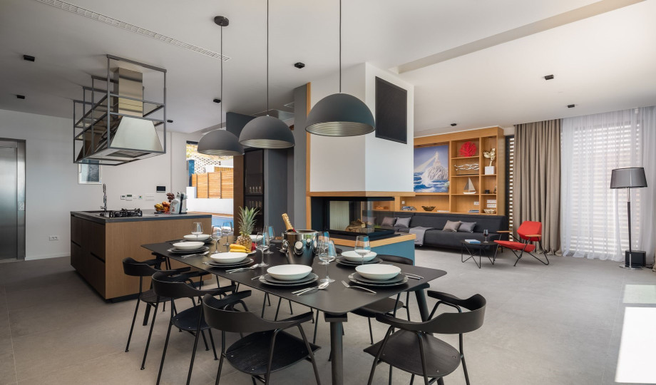 There is a very high standard fully fitted kitchen with prestige appliances and a dining area for 8 people, with amazing sea views