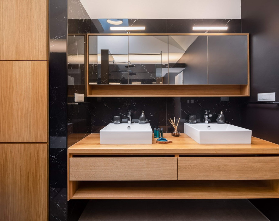 An en-suite bathroom with a bathtub and a shower, a double sink, a toilet, and a bidet
