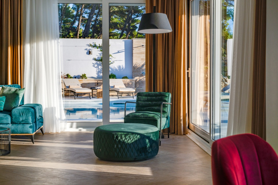 Spacious living room out looking to the pool area.