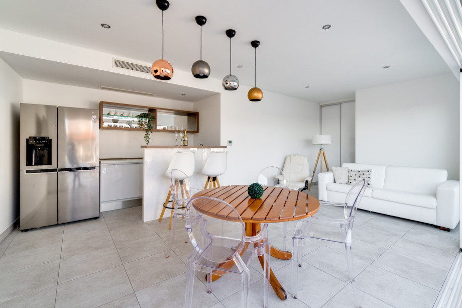 Modern summer kitchen and lounge area next to the pool