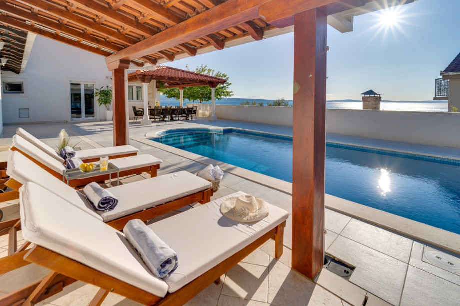 A very spacious sun deck area with 8 deck chairs and two covered areas