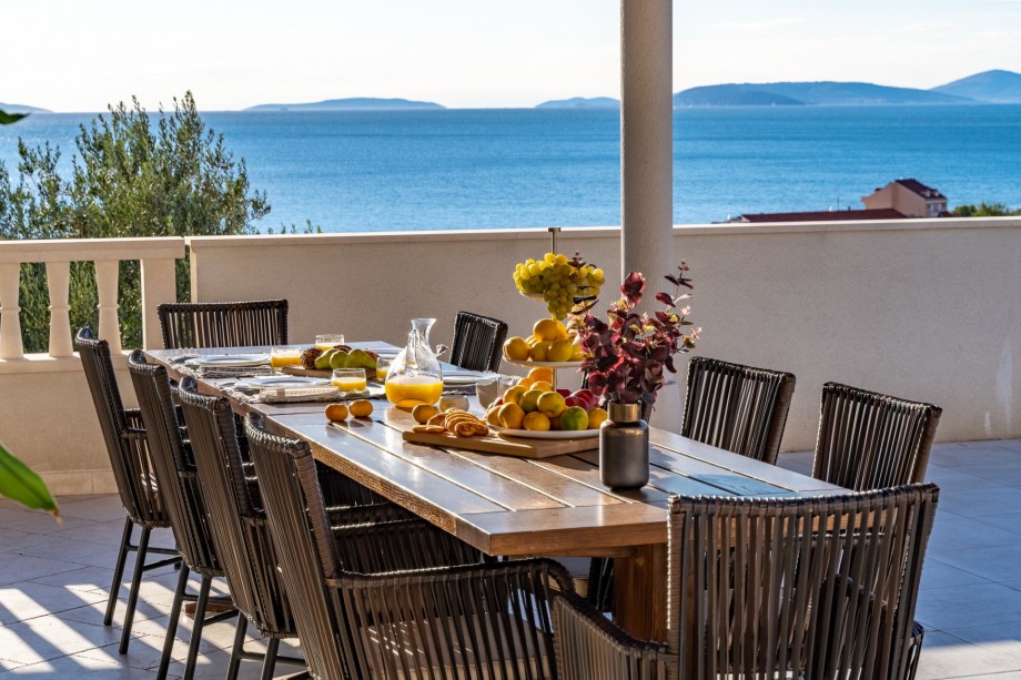 Covered outdoor dining area for 10 people with sea view