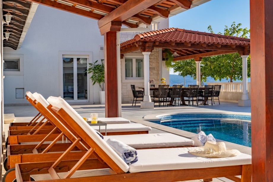 A very spacious sun deck area with 8 deck chairs and two covered areas