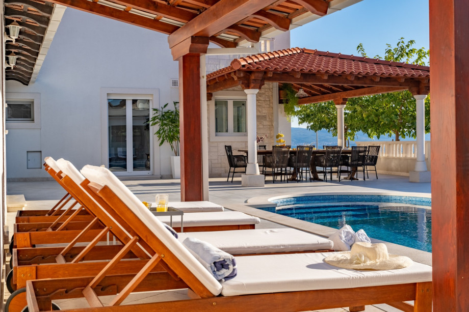 A very spacious sun deck area with 8 deck chairs and two covered areas