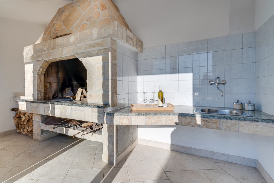 Traditional barbecue area next to the summer kitchen