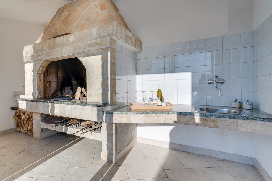 Traditional barbecue area next to the summer kitchen