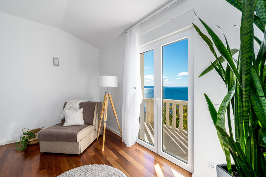 Bedroom No3 with a King size bed, a sofa for 1 person, a balcony with a sea view