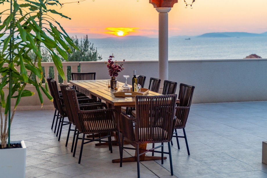 Covered outdoor dining area for 10 people with sunset view