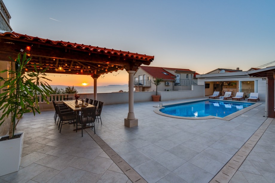 Covered outdoor dining area for 10 people with sunset view