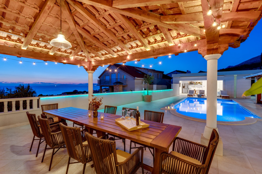 Covered outdoor dining area for 10 people with sunset view