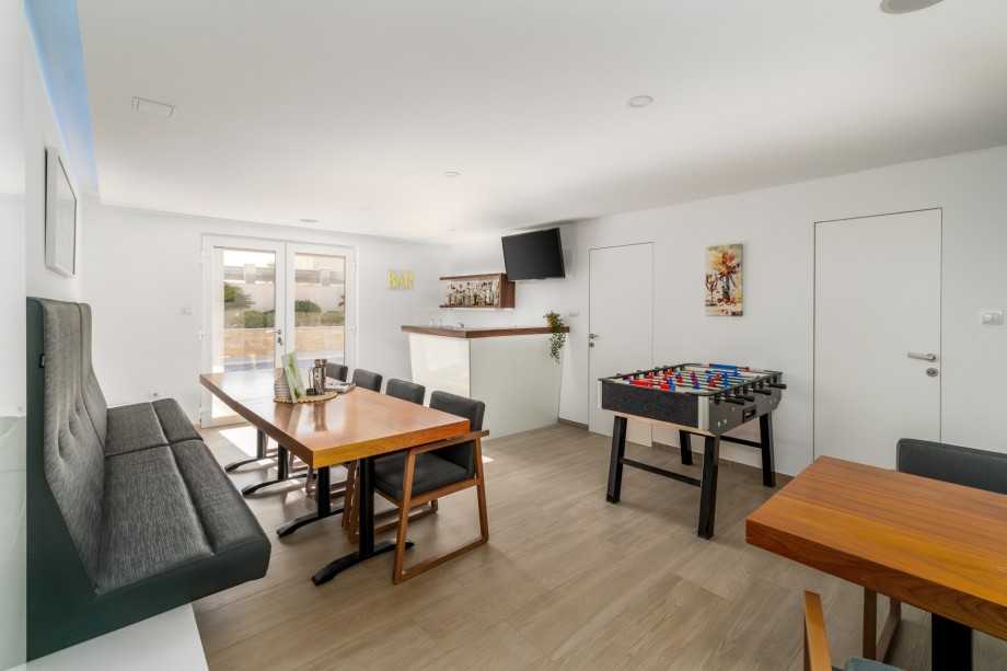 Conference room/fun zone with TV, table football, room with a running trail