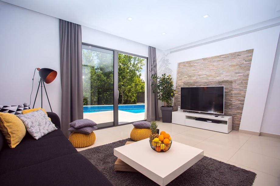 Comfortable living area with exit to the Pool area