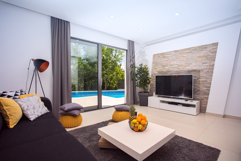 Comfortable living area with exit to the Pool area