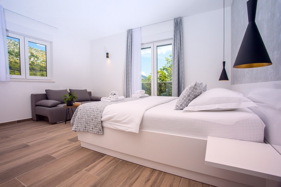 Bedroom No.1 with double bed& sofa bed& en-suite Bathroom & exit to the terrace