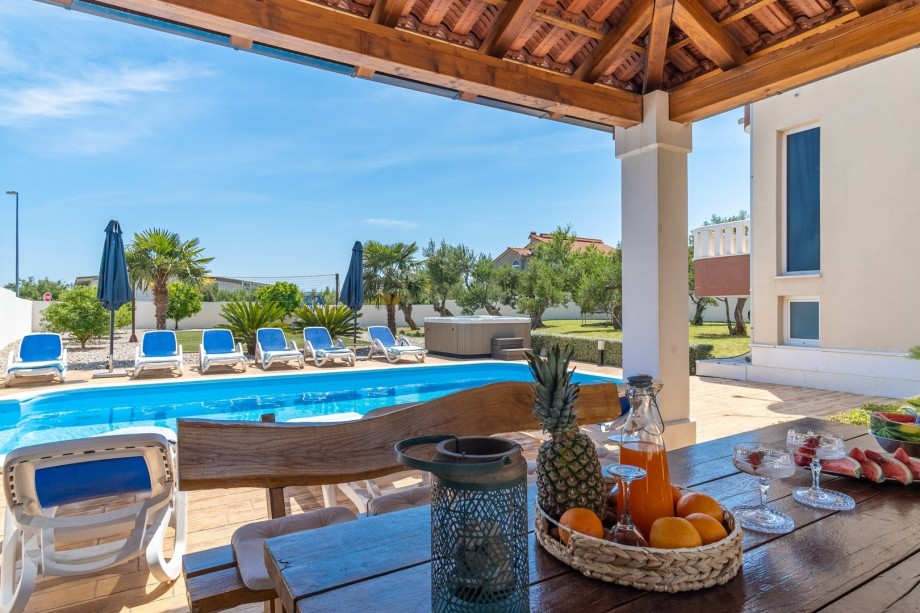 covered outdoor dining area with barbecue, table soccer