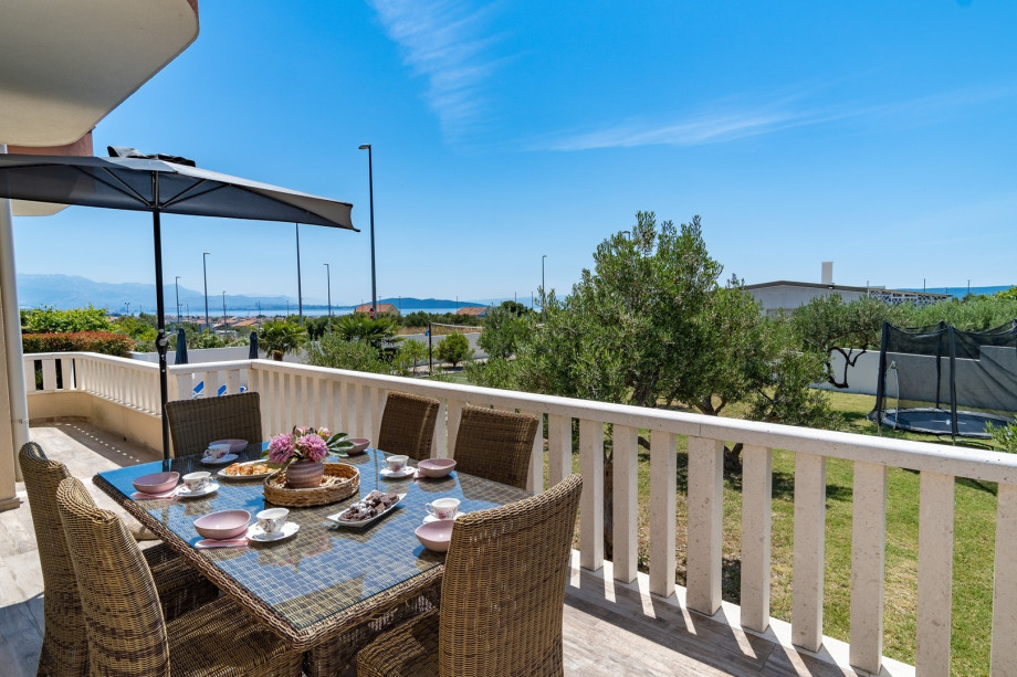 an outide sitting area with a pool view