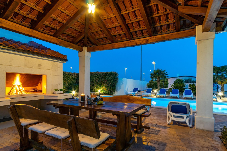 covered outdoor dining area with barbecue, table soccer