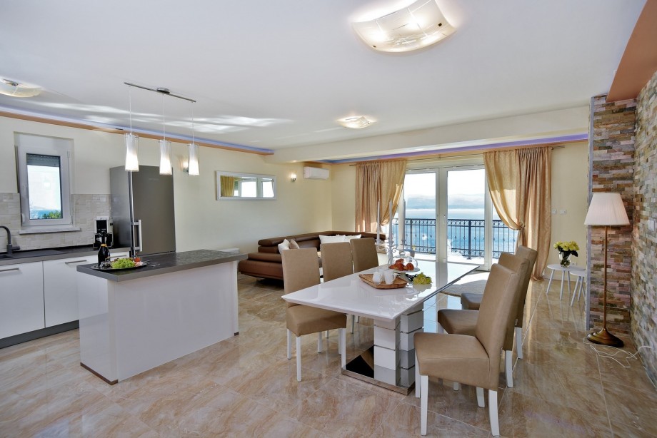 The first floor (pool level) offers an open concept living and dining room with a fully equipped kitchen
