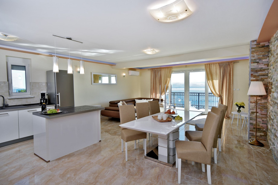The first floor (pool level) offers an open concept living and dining room with a fully equipped kitchen