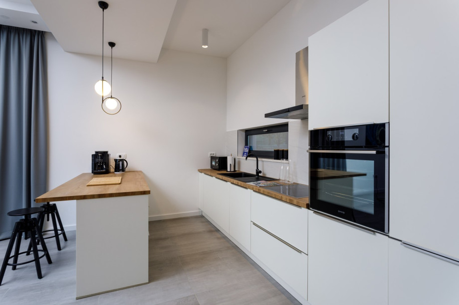 Direct approach toward outdoor dining area, an indoor dining area and a family bathroom with a shower.