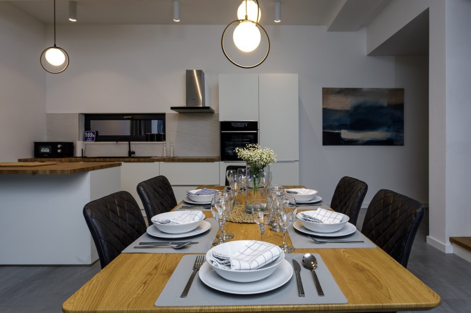 An indoor dining area and a family bathroom with a shower.