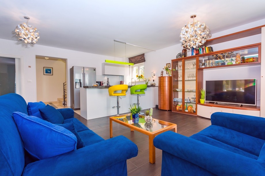 Living room offers comfy sofas, TV, air-condition