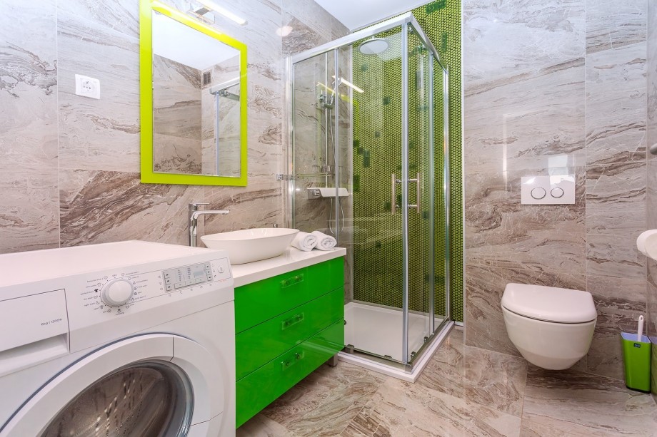 A family Bathroom with shower and a washing machine