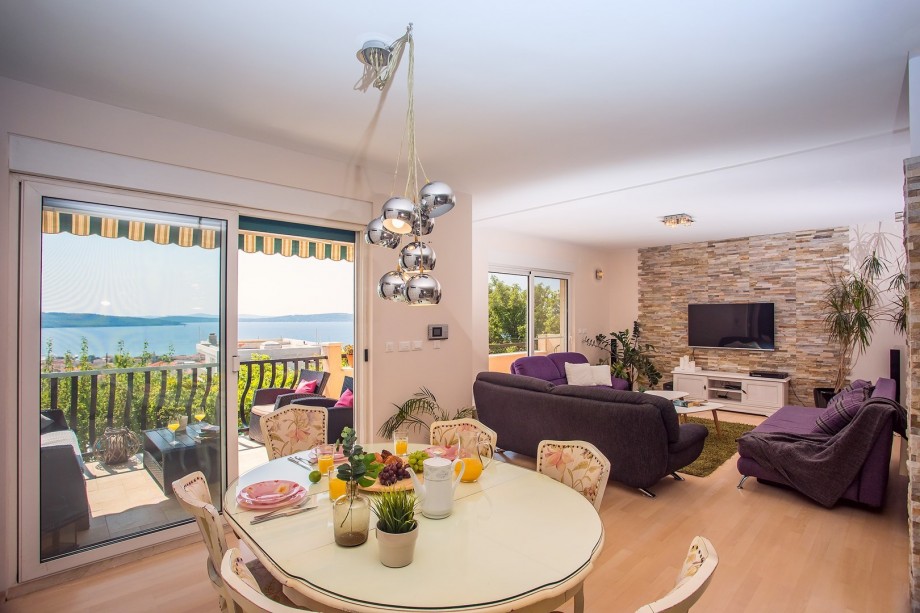 The living room is equipped with TV and PS4 and exit to the balcony.