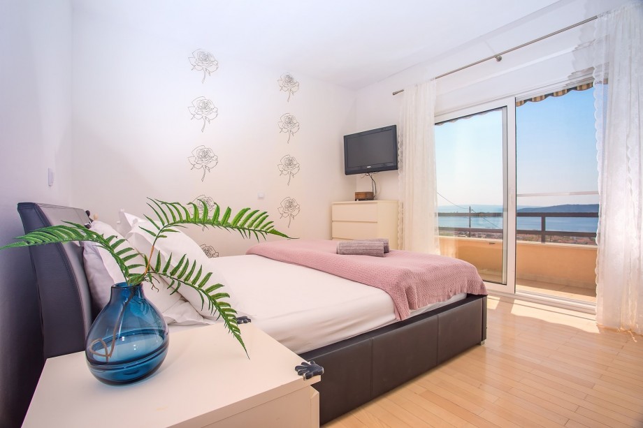 Bedroom No1 with king-size bed 180cm x 200cm, a TV, and a balcony with sea views