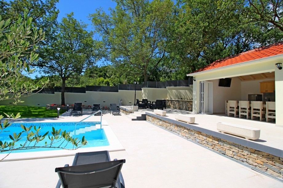 View on outdoor area with pool and sun deck
